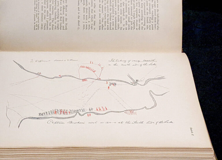 Printed in a book, a sketch of a battle by Shanawdithit. Neat handwriting frames the drawing, saying: "2 Different scenes & times." Writing on the top says: The taking of Mary March on the north side of the lake. On the bottom: Captain Buchani visit in 1810-11 at the south side of the lake. Sparse line drawings show the contour of a river both at the top and the bottom of the page. Red icons represent Beothuk people and black icons represent the British.